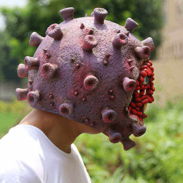 coronavirus latex face mask halloween prop, corona virus halloween mask, the model with the mask is looking down the road